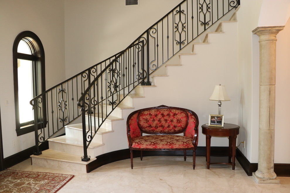 Mid-sized tuscan limestone floor and beige floor foyer photo in Tampa with white walls