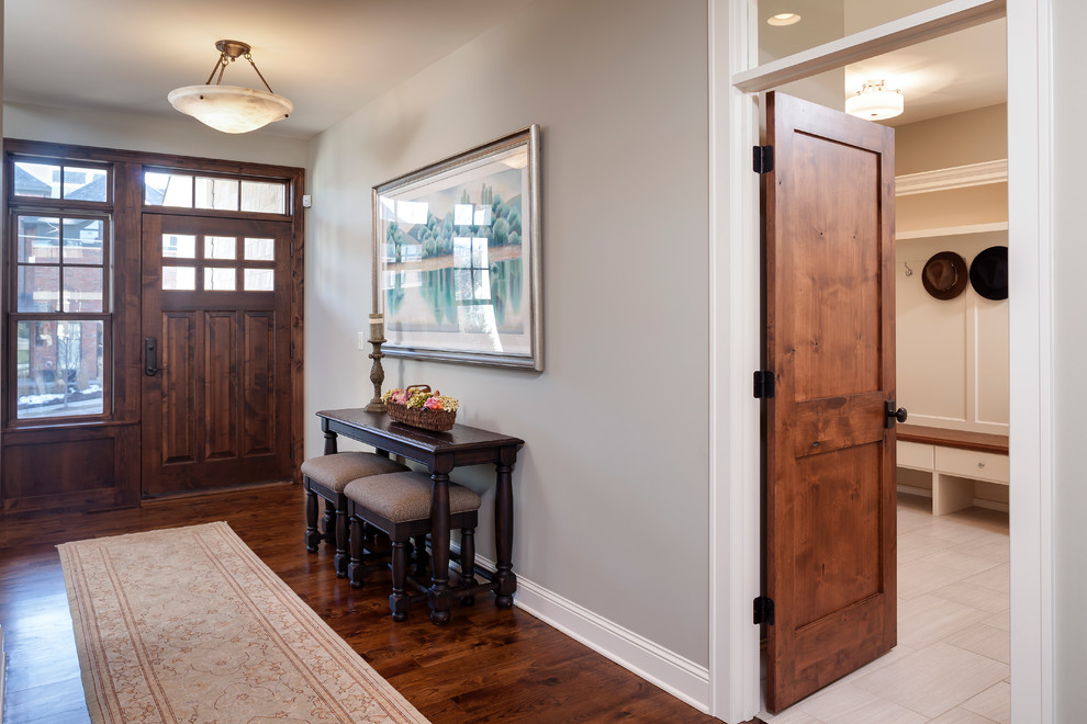 Medium sized traditional foyer in Minneapolis with grey walls, medium hardwood flooring and a dark wood front door.