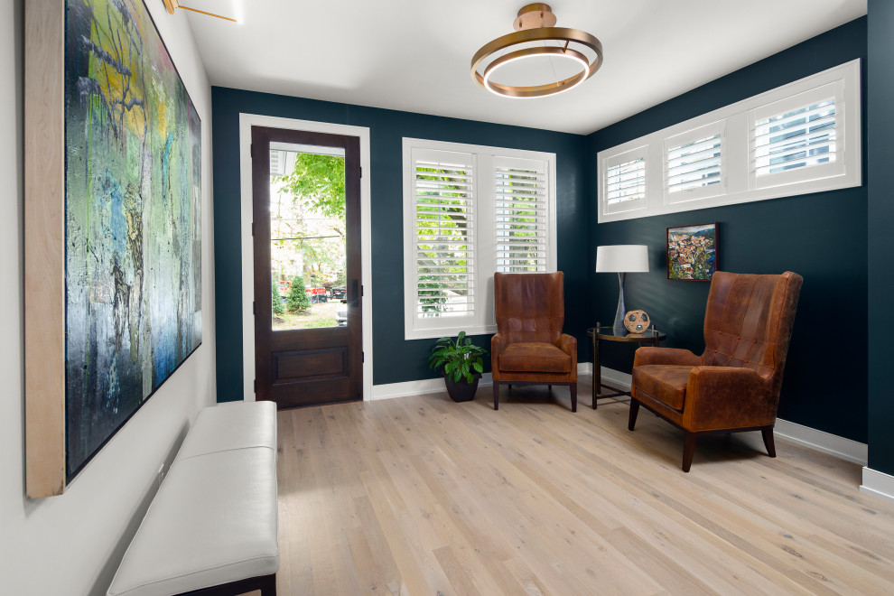 Inspiration for a mid-sized modern light wood floor and brown floor entryway remodel in Minneapolis with blue walls and a dark wood front door