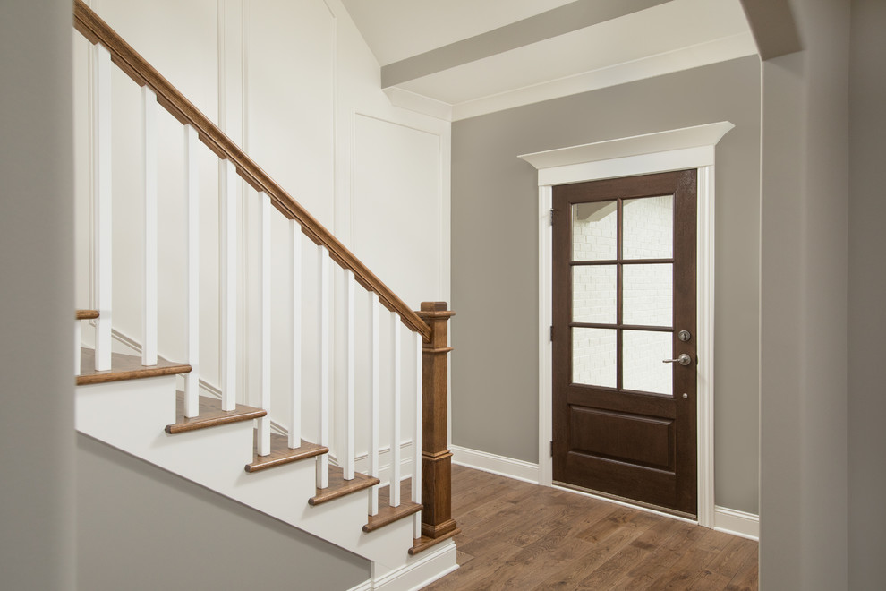 Photo of a medium sized classic front door in Other with grey walls, dark hardwood flooring, a single front door, a dark wood front door and brown floors.