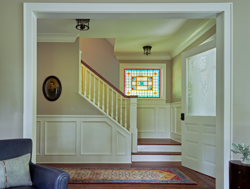 Photo of a classic foyer in New York with beige walls, dark hardwood flooring, brown floors and a single front door.