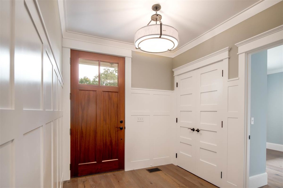This is an example of a medium sized classic entrance in Boston with beige walls, medium hardwood flooring, a single front door and a medium wood front door.