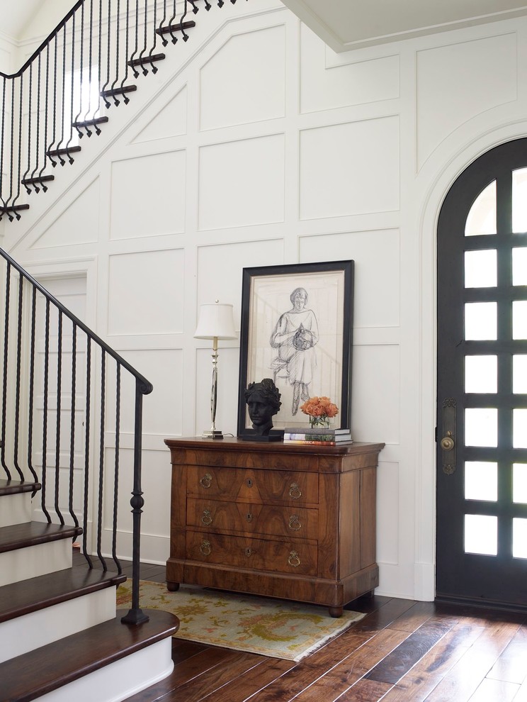 Inspiration for a traditional foyer in Houston with white walls, dark hardwood flooring, a single front door, a black front door and feature lighting.
