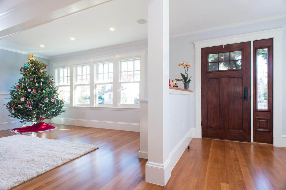 Inspiration for a medium sized classic front door in Boston with grey walls, light hardwood flooring, a single front door, a dark wood front door and brown floors.