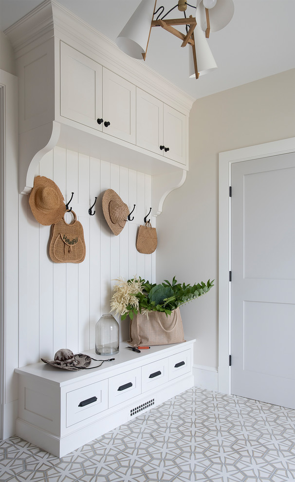 Inspiration for a nautical boot room in Portland Maine with beige walls and multi-coloured floors.