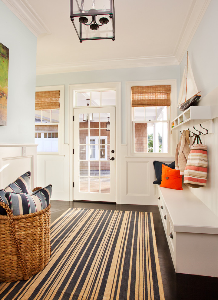 Large nautical boot room in Portland with blue walls, a single front door, a glass front door and dark hardwood flooring.