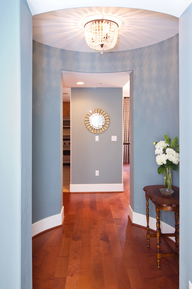 Inspiration for a mid-sized transitional medium tone wood floor and brown floor foyer remodel in Los Angeles with blue walls