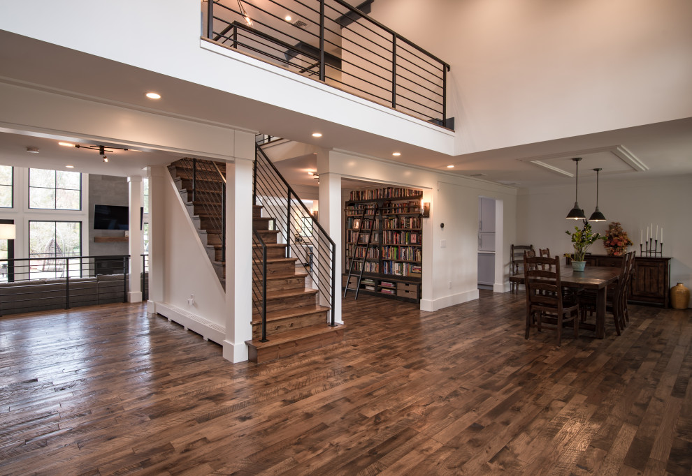 Photo of an expansive modern foyer in New York with dark hardwood flooring and brown floors.