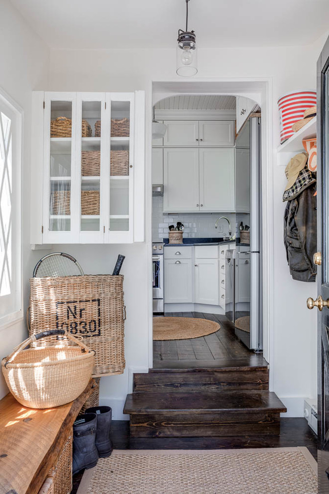 Inspiration for a small shabby-chic style medium tone wood floor and brown floor entryway remodel in Boston with white walls and a black front door