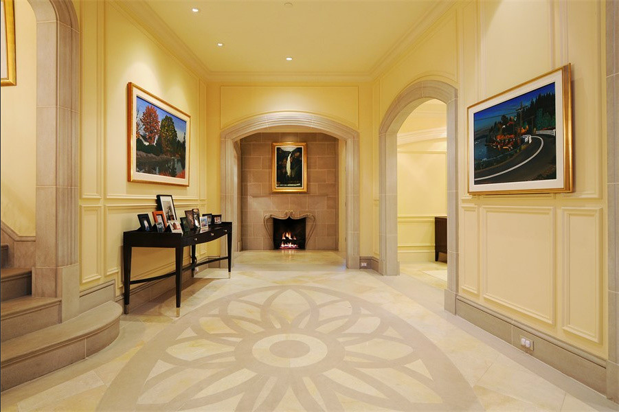 This is an example of a mediterranean entrance in Vancouver with beige walls, limestone flooring and a single front door.