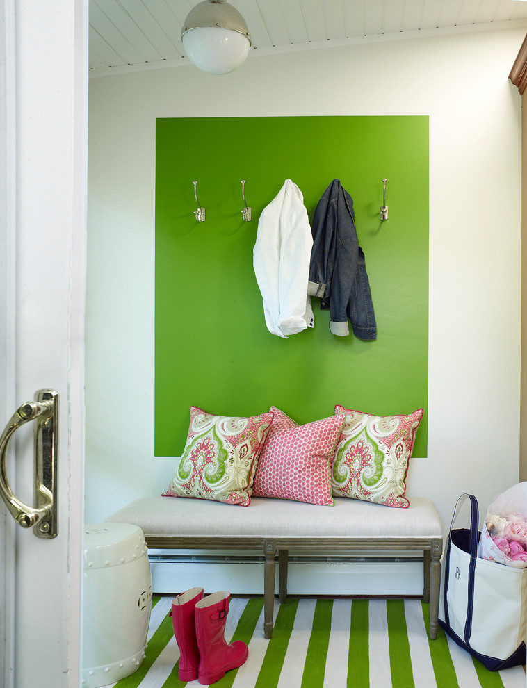 Cette photo montre un petit vestibule chic avec un mur vert, un sol en bois brun, une porte blanche et une porte simple.