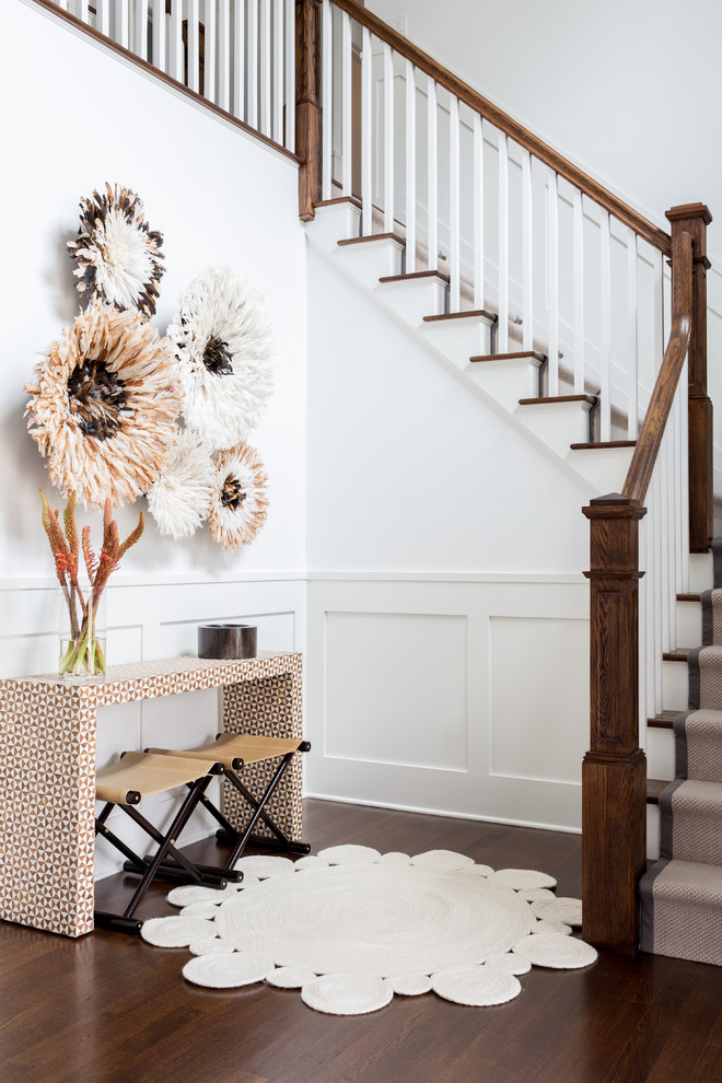 Large trendy medium tone wood floor and brown floor entryway photo in New York with white walls and a white front door
