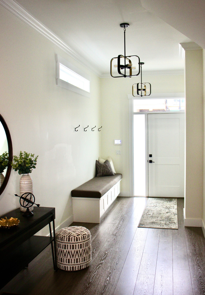 Design ideas for a medium sized modern hallway in Vancouver with white walls, medium hardwood flooring, a single front door, a white front door, brown floors and exposed beams.