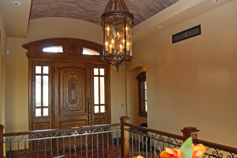 Large rustic foyer in Minneapolis with beige walls, medium hardwood flooring, a single front door and a dark wood front door.