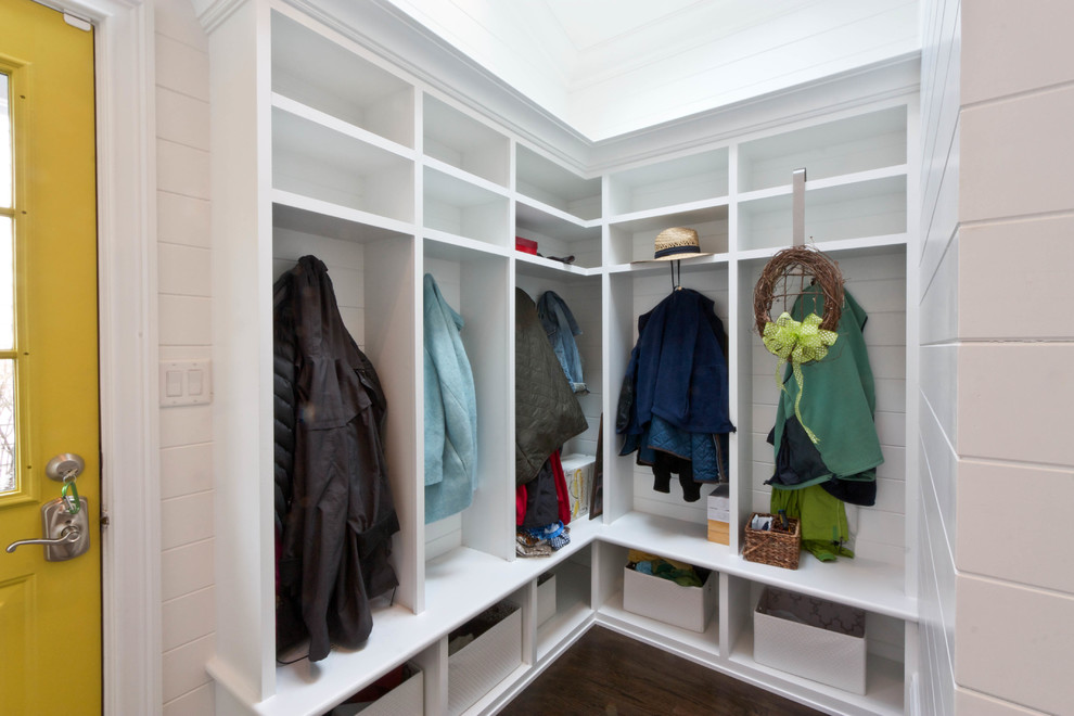 This is an example of a traditional boot room in Newark with white walls, dark hardwood flooring, a single front door and a yellow front door.