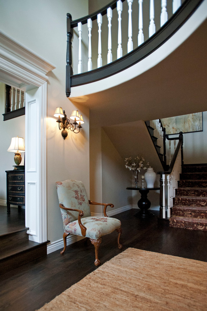Example of a large classic dark wood floor foyer design in Los Angeles with beige walls