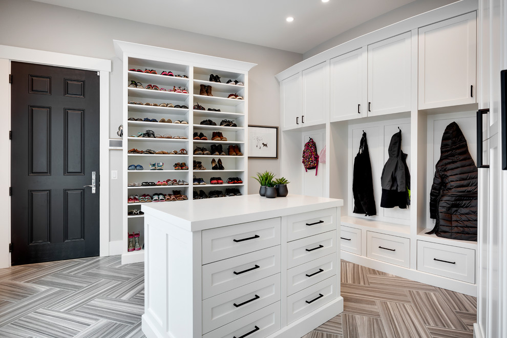 Mudroom - huge transitional porcelain tile and gray floor mudroom idea in Calgary with gray walls