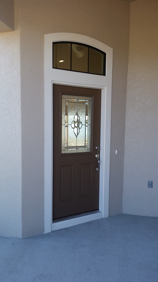 Example of a mid-sized transitional ceramic tile entryway design in Orlando with beige walls