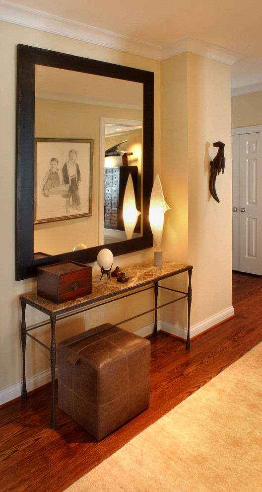 Design ideas for a medium sized eclectic entrance in St Louis with yellow walls and medium hardwood flooring.