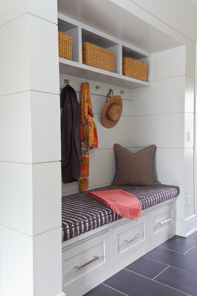 Beach style boot room in New York with white walls.