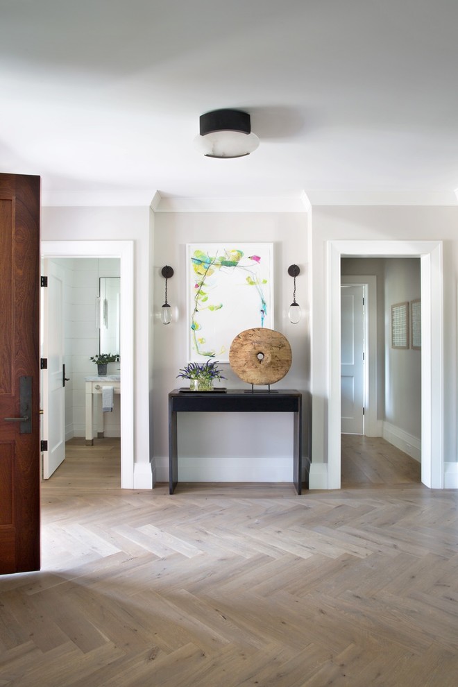 Inspiration for a mid-sized transitional medium tone wood floor and beige floor entryway remodel in Other with gray walls and a dark wood front door
