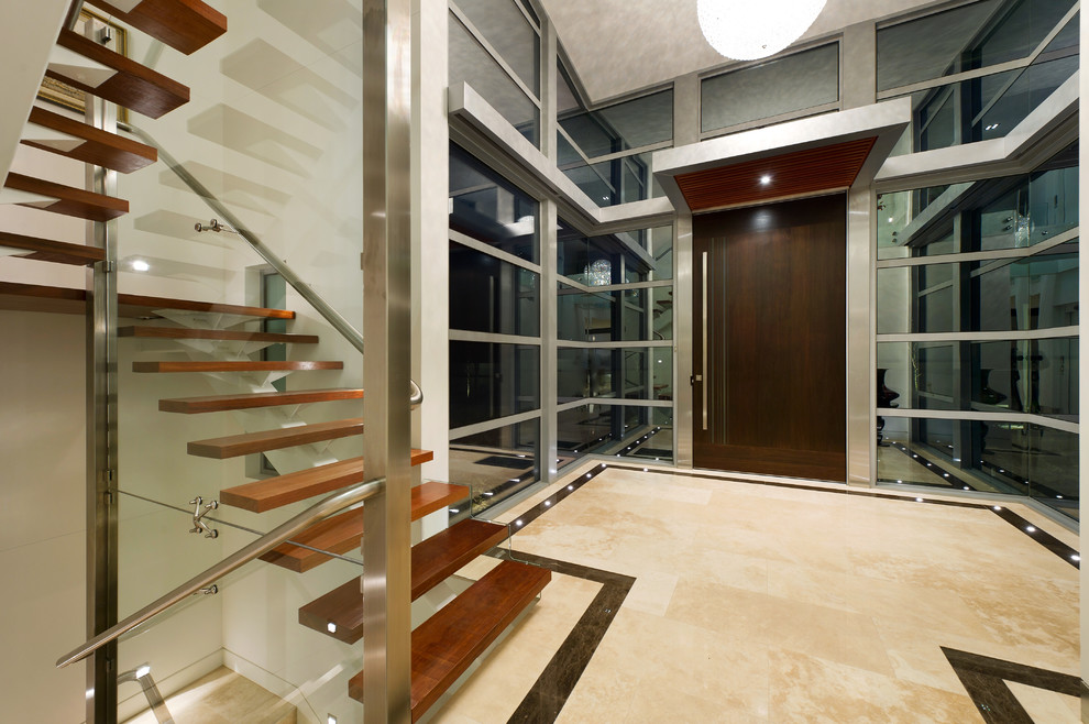 Photo of a contemporary foyer in Melbourne with a single front door and a dark wood front door.