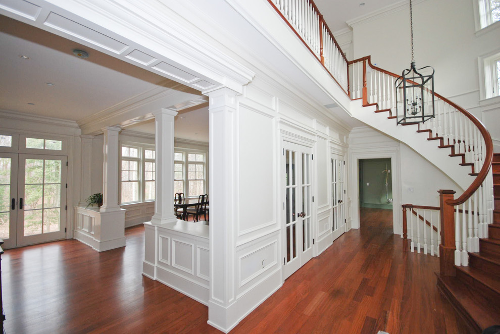 Entryway - mid-sized traditional medium tone wood floor entryway idea in DC Metro with white walls