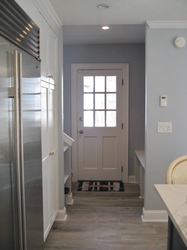 Ejemplo de hall clásico renovado de tamaño medio con paredes grises, suelo de baldosas de porcelana, puerta simple, puerta blanca y suelo marrón