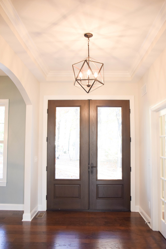Mid-sized farmhouse dark wood floor entryway photo in Cleveland with white walls and a dark wood front door