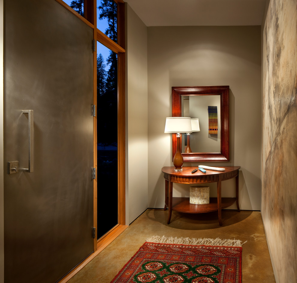 Contemporary entrance in Other with concrete flooring.