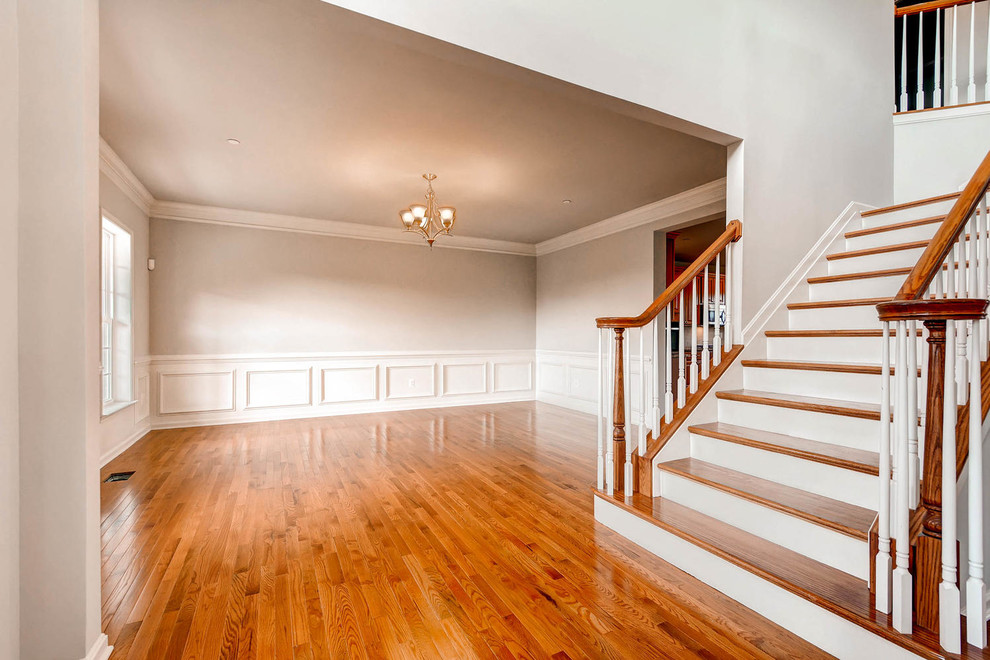 Large classic foyer in Baltimore with grey walls, medium hardwood flooring and brown floors.
