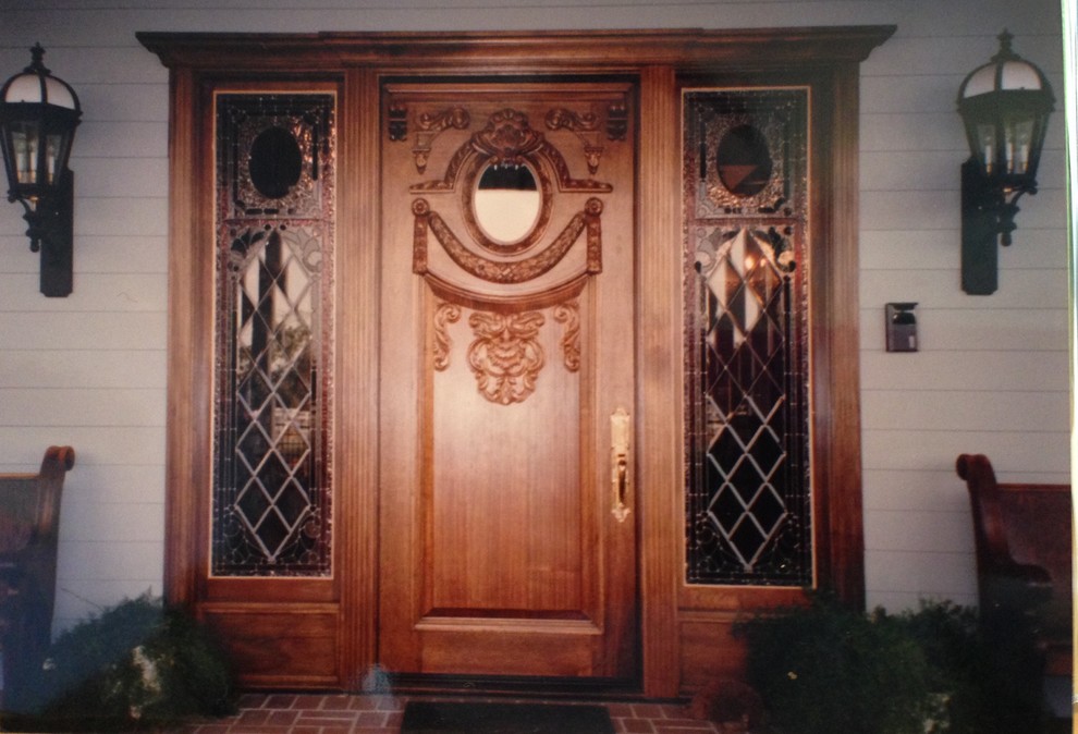 This is an example of an expansive victorian front door in Other with grey walls, brick flooring, a single front door and a medium wood front door.