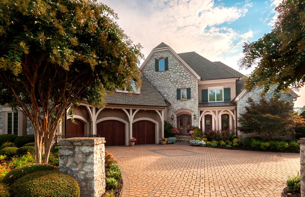 Photo of a large entrance in Charlotte with brick flooring, a double front door, a brown front door and brown floors.