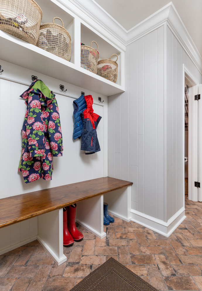 Farmhouse brown floor and porcelain tile mudroom photo in Philadelphia with gray walls