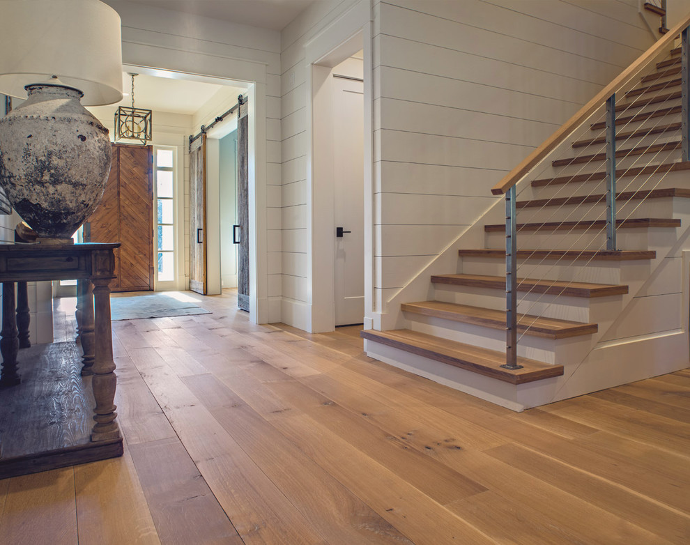 Foyer - large country medium tone wood floor foyer idea in Atlanta with white walls and a medium wood front door