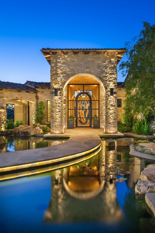 Mediterranean entrance in San Diego with a glass front door.
