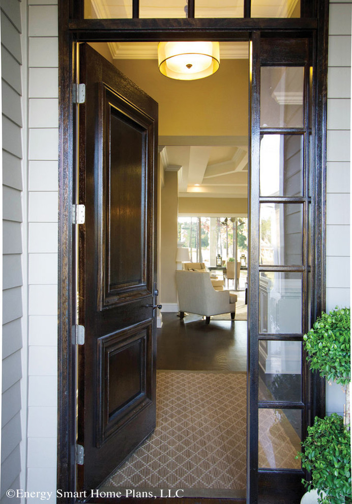 This is an example of a medium sized classic front door in Wilmington with beige walls, medium hardwood flooring, a single front door and a dark wood front door.