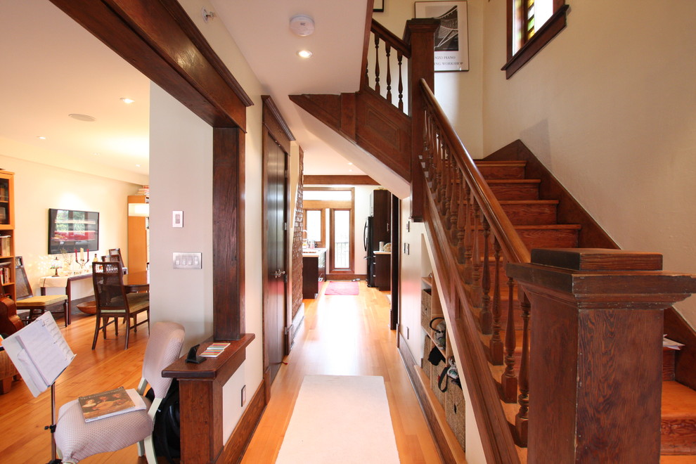 Mid-sized elegant light wood floor entryway photo in Vancouver with gray walls and a dark wood front door