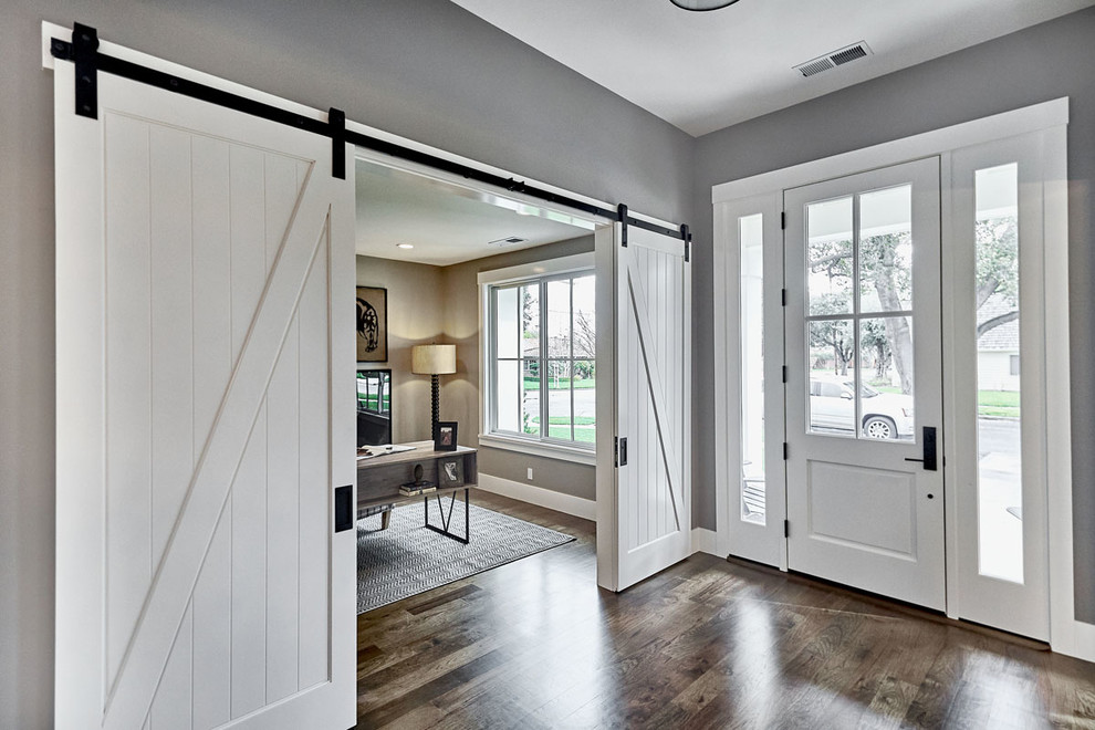 Inspiration for a large country front door in San Francisco with grey walls, medium hardwood flooring, a single front door, a white front door, grey floors and feature lighting.