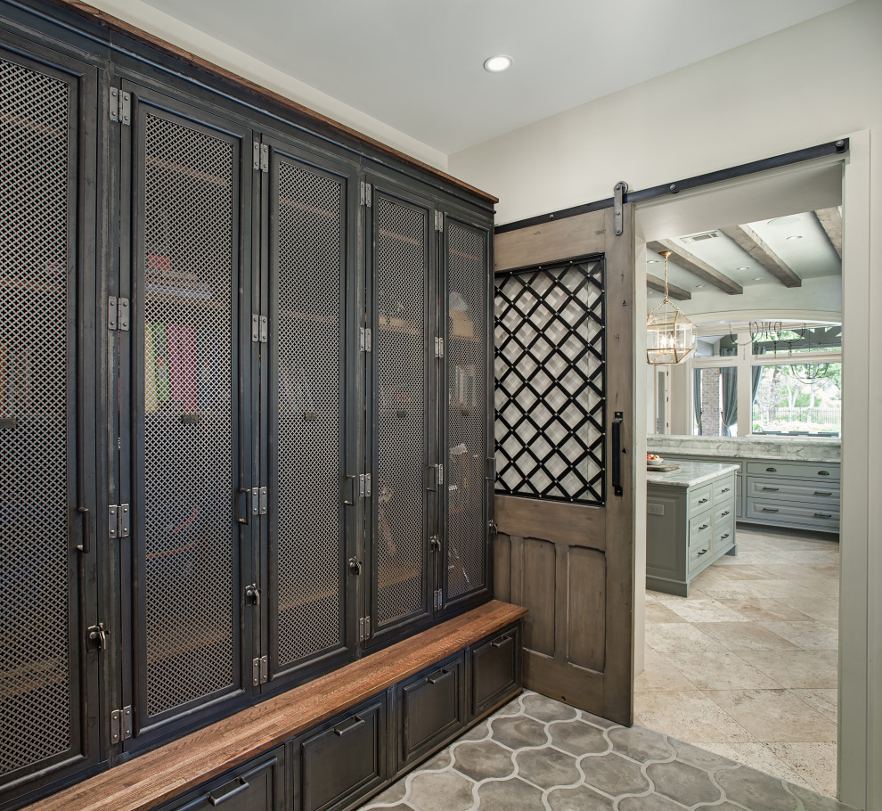 This is an example of a medium sized traditional boot room in Houston with grey walls, grey floors, concrete flooring, a single front door and a white front door.