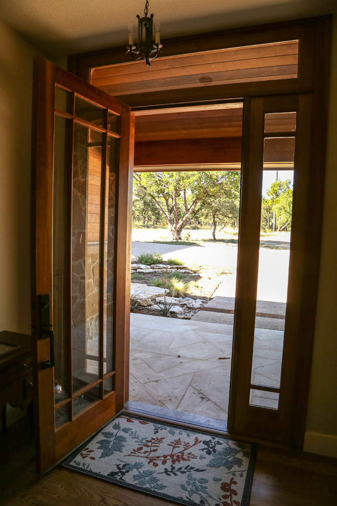 Cette image montre une porte d'entrée craftsman de taille moyenne avec un mur beige, parquet clair, une porte simple et une porte en bois clair.