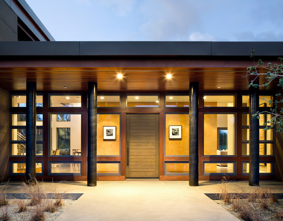 Inspiration for a contemporary front door in San Francisco with a single front door and a dark wood front door.