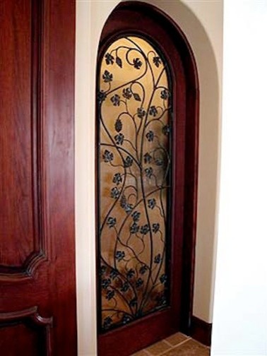 Inspiration for a mid-sized mediterranean entryway remodel in Los Angeles with a medium wood front door and beige walls