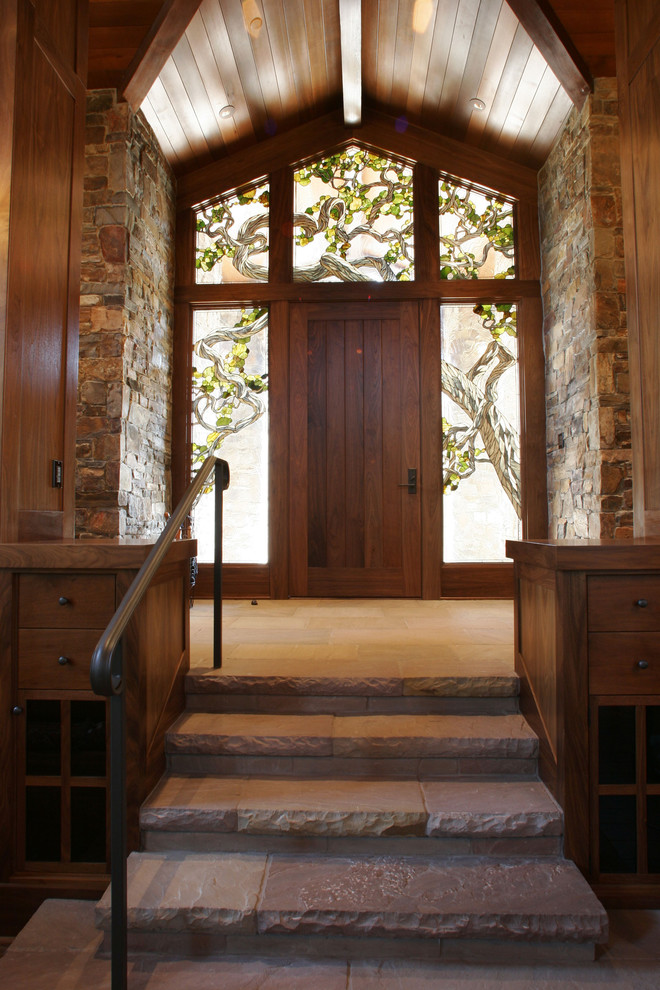 Example of a mountain style entryway design in San Francisco with a dark wood front door