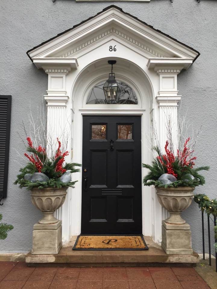 This is an example of a small classic front door in New York with grey walls, a single front door and a black front door.