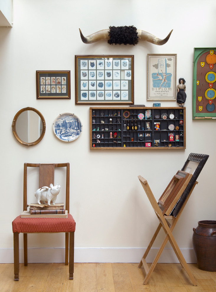 Inspiration for an eclectic entrance in London with white walls and medium hardwood flooring.