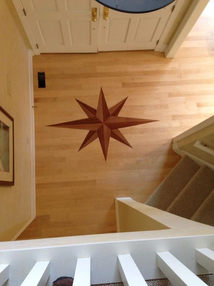 Inspiration for a mid-sized timeless light wood floor foyer remodel in Baltimore with beige walls