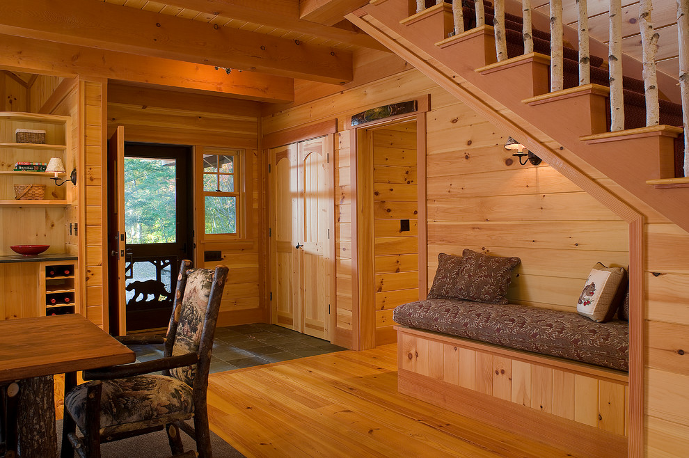 Example of a mountain style light wood floor entryway design in Boston