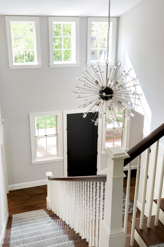 Photo of a large traditional foyer in Minneapolis with white walls, medium hardwood flooring, a single front door, a medium wood front door and brown floors.
