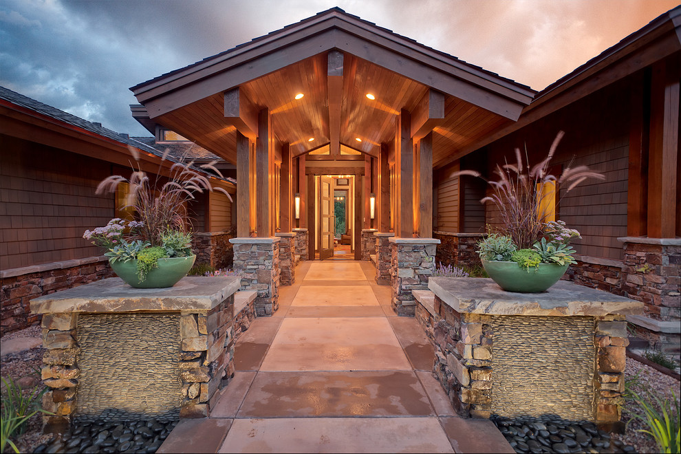 Photo of an expansive traditional front door in Salt Lake City with a pivot front door, a medium wood front door, brown walls and slate flooring.